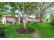 Relaxing backyard with a swing chair, patio set, and a pergola next to a sunroom, perfect for outdoor entertainment at 714 Regina Cir, Oakland, FL 34787