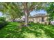 Serene backyard oasis with mature trees offering shade and a relaxing swing set at 714 Regina Cir, Oakland, FL 34787