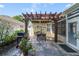 Charming patio featuring a pergola, a dining table, and a grill for outdoor entertaining at 714 Regina Cir, Oakland, FL 34787