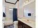 This hall bathroom features a single sink, white tile, and shower-tub combo at 714 Regina Cir, Oakland, FL 34787