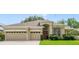 Charming home featuring a three-car garage, manicured lawn, and beautiful landscaping at 714 Regina Cir, Oakland, FL 34787