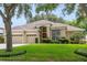 Well-maintained home featuring a three-car garage, lush landscaping, and inviting curb appeal at 714 Regina Cir, Oakland, FL 34787