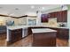 Spacious kitchen with granite counters, stainless appliances, and an island at 714 Regina Cir, Oakland, FL 34787