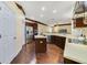Kitchen with wood cabinets, stainless appliances, and center island at 714 Regina Cir, Oakland, FL 34787