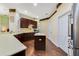 Open kitchen featuring dark wood cabinetry and stainless steel appliances at 714 Regina Cir, Oakland, FL 34787