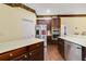 Kitchen with stainless steel appliances and dark wood cabinets at 714 Regina Cir, Oakland, FL 34787