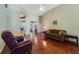 Inviting living room with hardwood floors, ceiling fan, and neutral color scheme, great for relaxing at 714 Regina Cir, Oakland, FL 34787