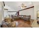 Spacious living room with hardwood floors and an oversized sectional couch at 714 Regina Cir, Oakland, FL 34787