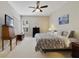 Well-lit main bedroom with neutral decor, carpeted floors, ceiling fan and good natural light at 714 Regina Cir, Oakland, FL 34787
