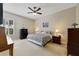 Comfortable main bedroom featuring neutral paint, ceiling fan, and carpeted floors at 714 Regina Cir, Oakland, FL 34787
