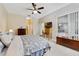 Lovely main bedroom with a ceiling fan, good lighting, and an ensuite bathroom at 714 Regina Cir, Oakland, FL 34787