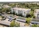 Aerial view of a condominium complex, highlighting the building's layout, surrounding greenery, and individual garages at 7505 Mourning Dove Cir # 201, Reunion, FL 34747