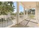 A large balcony with white pillars and railings offers expansive neighborhood views at 7505 Mourning Dove Cir # 201, Reunion, FL 34747