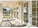 Relaxing covered balcony featuring French doors and beautiful green views at 7505 Mourning Dove Cir # 201, Reunion, FL 34747