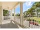 Spacious balcony featuring classic white columns with views of lush landscaping and nearby buildings at 7505 Mourning Dove Cir # 201, Reunion, FL 34747