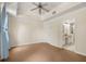 Bright bedroom featuring neutral walls, patterned carpet, and an ensuite bathroom at 7505 Mourning Dove Cir # 201, Reunion, FL 34747