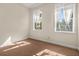 Bright bedroom featuring neutral walls, patterned carpet, and windows with white, sheer curtains at 7505 Mourning Dove Cir # 201, Reunion, FL 34747