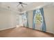 Spacious bedroom featuring neutral walls, patterned carpet, and windows dressed with blue curtains at 7505 Mourning Dove Cir # 201, Reunion, FL 34747