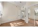 Bedroom features neutral walls, patterned carpet, closet with mirrored doors, and an open door to another room at 7505 Mourning Dove Cir # 201, Reunion, FL 34747
