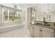 Bright kitchen with granite countertops, a breakfast bar, and a large window, creating a welcoming space at 7505 Mourning Dove Cir # 201, Reunion, FL 34747