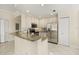 Modern kitchen featuring stainless steel appliances, granite countertops, and ample storage space in white cabinetry at 7505 Mourning Dove Cir # 201, Reunion, FL 34747