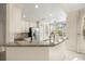 Stylish kitchen featuring granite countertops, stainless steel appliances, and plenty of natural light from the window at 7505 Mourning Dove Cir # 201, Reunion, FL 34747