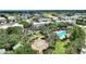 Scenic aerial view of a community with a pool, green spaces, and surrounding buildings at 7509 Mourning Dove Cir # 201, Reunion, FL 34747