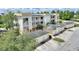 Aerial view of a yellow/white complex with well-kept landscaping and dedicated garages at 7509 Mourning Dove Cir # 201, Reunion, FL 34747