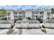 Aerial view of a yellow apartment complex with white garages and mature landscaping at 7509 Mourning Dove Cir # 201, Reunion, FL 34747