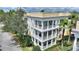 Exterior aerial view of a white/yellow multi-story building with charming outdoor balconies at 7509 Mourning Dove Cir # 201, Reunion, FL 34747