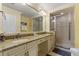 Bright bathroom with a double sink vanity with granite countertops, and a walk-in shower at 7509 Mourning Dove Cir # 201, Reunion, FL 34747