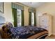 Bright bedroom features 2 windows, green curtains, and a white wooden cabinet at 7509 Mourning Dove Cir # 201, Reunion, FL 34747