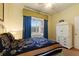 This bedroom has a large window, spacious closet, carpet, and a decorative ceiling fan at 7509 Mourning Dove Cir # 201, Reunion, FL 34747