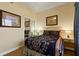 Cozy bedroom showcasing tasteful wall art, a mirrored closet, and ample light from bedside lamps at 7509 Mourning Dove Cir # 201, Reunion, FL 34747