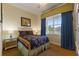 Comfortable bedroom featuring a large window, bedside table, and ample natural light at 7509 Mourning Dove Cir # 201, Reunion, FL 34747