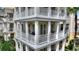 Close up of a three-story condo featuring balconies with classic architectural details at 7509 Mourning Dove Cir # 201, Reunion, FL 34747
