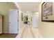 Inviting hallway with tiled floor leading to a bright living area, enhanced by tasteful decor at 7509 Mourning Dove Cir # 201, Reunion, FL 34747