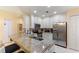 Modern kitchen featuring granite countertops, stainless steel appliances, and white cabinetry at 7509 Mourning Dove Cir # 201, Reunion, FL 34747