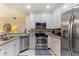 Well-equipped kitchen with stainless steel appliances and ample counter space for cooking at 7509 Mourning Dove Cir # 201, Reunion, FL 34747