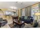 Comfortable living room featuring elegant decor, a full dining set, and an open view to the kitchen at 7509 Mourning Dove Cir # 201, Reunion, FL 34747