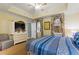 Spacious main bedroom with a trey ceiling, carpet, tv console, and light-colored walls at 7509 Mourning Dove Cir # 201, Reunion, FL 34747
