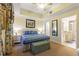 This main bedroom has a tray ceiling, soft carpet, and an en suite bathroom with double sinks at 7509 Mourning Dove Cir # 201, Reunion, FL 34747