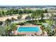 Community pool with lounge chairs, fountain, and palm trees, perfect for relaxation and recreation at 7509 Mourning Dove Cir # 201, Reunion, FL 34747