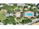Aerial shot of a resort-style pool area with fountain, gazebos, palm trees, and lounge chairs at 7509 Mourning Dove Cir # 201, Reunion, FL 34747