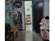 Another angle of a cozy bedroom with shelving and access to the adjacent room at 8704 Tom Costine Rd, Lakeland, FL 33809