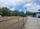 Expansive outdoor space with a driveway leading to a charming blue home at 8704 Tom Costine Rd, Lakeland, FL 33809