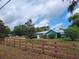 Charming blue home with a spacious front yard and a classic wooden fence at 8704 Tom Costine Rd, Lakeland, FL 33809