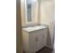 Bathroom featuring a marble-look countertop, framed mirror, and white wood cabinets at 8750 Se 88Th Ave, Ocala, FL 34472