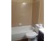 The bathroom features a tub and shower combo with tiled walls and a toilet next to the vanity at 8750 Se 88Th Ave, Ocala, FL 34472
