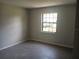 This bedroom features tile floors and a large window that provides plenty of natural light at 8750 Se 88Th Ave, Ocala, FL 34472